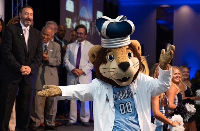 Photo of ODU's mascot dancing in front of a group of people.